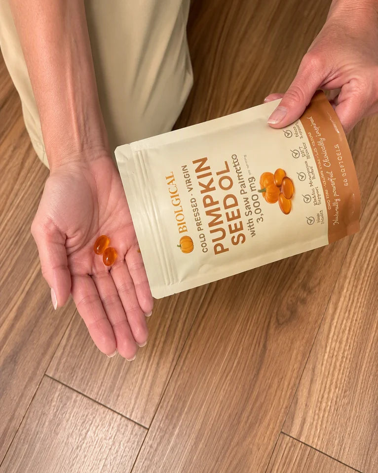 Two softgels tipped from the pouch into a palm